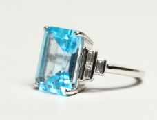 AN IMPRESSIVE 18CT WHITE GOLD, BLUE TOPAZ AND DIAMOND RING, the rectangular cut topaz, approx. 9.