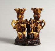 AN UNUSUAL SLIP/TREACLE GLAZED POTTERY PEN STAND/VASE, possibly Chanakkale Turkish.