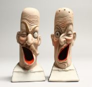 A PAIR OF POTTERY MEN'S HEADS ASHTRAYS. 5in high.