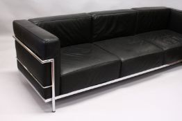 IN THE MANNER OF LE CORBUSTIER, A LARGE CHROME FRAMED THREE SEATS SETTEE, with black leather