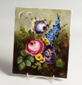 A GERMAN PORCELAIN PLAQUE PAINTED with flowers 9ins x 7.25ins
