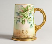 A BEELEEK PORCELAIN TANKARD H. P. C. C. decorated with hops 5.5ins high.