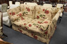 A GOOD MODERN KNOLL LARGE TWO SEATER SETTEE, upholstered in a broad floral print fabric