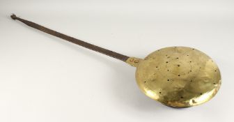 A QUEEN ANN BRASS WARMING PAN with metal handle