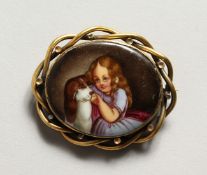 A VICTORIAN OVAL PORCELAIN BROOCH of a young girl with a dog.