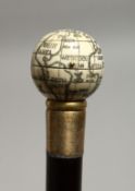 A WALKING STICK WITH A GLOBE COMPASS