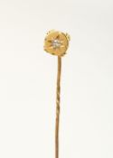 A GOLD AND DIAMOND TIE PIN
