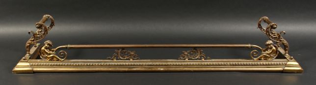 A VERY GOOD 19TH CENTURY BRASS FENDER, with cupid supports pierced and scrolling ends