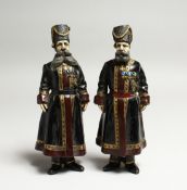 A PAIR OF RUSSIAN BRONZE FIGURES of two men in costume and wearing medals 7ins high