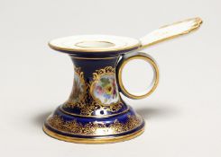 A SMALL MEISSEN CHAMBER STICK, blue ground painted with panels of flowers. Cross swords mark in