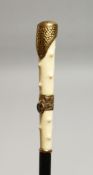 A WALKING CANE WITH GILT HANDLE 33ins long