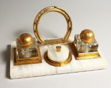 A GILT METAL AND WHITE ONYX EQUESTRIAN THEME DESK STAND 10.75 INS LONG