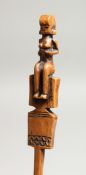 A CARVED WOOD TRIBAL HAIR PIN with figural top. 8.5ins long