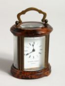 A GOOD CIRCULAR BRASS CARRIAGE CLOCK, MATTHEW NORMAN, LONDON. 3ins high.