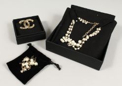 THREE DECORATIVE PIECES AFTER CHANEL, brooch, necklace, and bracelet.