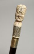 A WALKING STICK WITH A BONE HEAD 35ins long