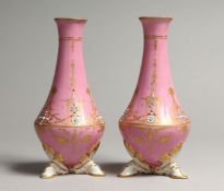A SMALL PAIR OF SEVRES PINK PORCELAIN VASES, gilt and seed pearl decoration, on three hoof feet.