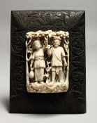 A GOOD CARVED AND PIERCED EUROPEAN IVORY OF A MAN AND A WOMAN IN AN ARBOUR. 3.5ins x 2.5ins on a