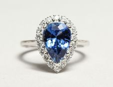 A GOOD 18CT WHITE GOLD, SAPPHIRE AND DIAMOND RING, the pear shape sapphire approx. 4ct, the