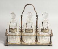 A VERY GOOD VICTORIAN, GILDED PLATE THREE BOTTLE DECANTER STAND, with oval bottles and stoppers,