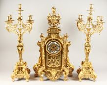 A LARGE FRENCH ORMOLU THREE PIECE CLOCK GARNITURE, the clock with urn finial, garlands, lion masks
