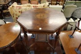 AN EDWARDIAN INLAID ROSEWOOOD OCTAGONAL TOP CENTRE TABLE with tapering legs and porcelain castors.