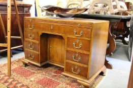 A GEORGE III MAHOGANY KNEEHOLE DESK with plain top and brushing side, long drawer over a kneehole