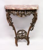 AN 18TH /19TH ITALIAN ROUGE MARBLE AND CARVED OAK CONSOLE TABLE, of serpentine outline, the top