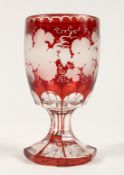 A GOOD BOHEMIAN RUBY GLASS GOBLET etched with fruiting vines on an octagonal base. 6ins high.