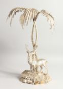 A VERY GOOD PLATED CENTREPIECE, a stag standing beneath a palm tree. 18ins high.