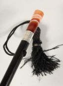 AN EDWARDIAN AGATE HANDLE CANE with silver band. J BURNSIDE 2ft 10ins long