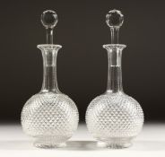 A GOOD PAIR OF HOBNAIL CUT PORT DECANTERS AND STOPPERS. 10.5ins high.