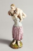 A 19TH CENTURY HORCH POTTERY GROUP, MOTHER AND CHILD, on a rustic base. Wheel mark 8.5ins high.
