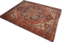A GOOD LARGE PERSIAN HERIZ CARPET, red ground with central medallion and stylised decoration. 13ft