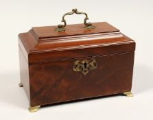 A GEORGE III MAHOGANY THREE DIVISION TEA CADDY with beaded top, brass carrying handles and
