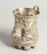 A VICTORIAN SILVER MUG with repousse decoration Sheffield 1884