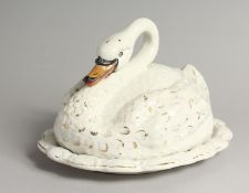 A STAFFORDSHIRE POTTERY CHEESE DISH AND COVER MODELLED AS A SWAN. 11ins long.