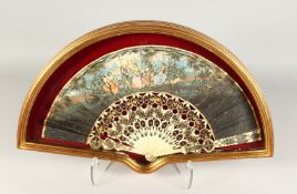A FRAMED AND GLAZED FRENCH FAN on paper with ivory. 12ins x 20ins