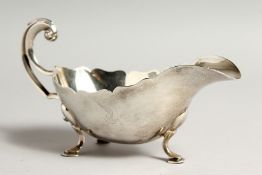 A GOOD HEAVY SILVER SAUCE BOAT with crest London 1935 Maker E.V. Weight 8ozs