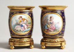 A SUPERB SMALL PAIR OF SEVRES PORCEALIN ORMULO MOUNTED VASES, painted with reverse panels of musical