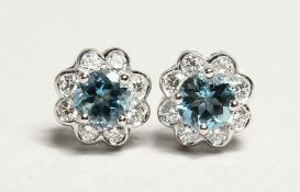 A PAIR OF 18CT. WHITE GOLD AND AQUAMARINE AND DIAMOND FLOWERHEAD DESIGN EAR STUDS. Aquamarine