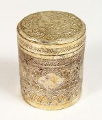 A BURMESE SILVER CIRCULAR BOX AND COVER 3.25ins high, 2.5ins diameter.