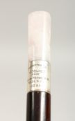 AN EDWARDIAN ROSE QUARTZ HANDLE CANE with silver band, presented to J MILNER 2ft 11ins long