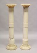 A GOOD PAIR OF ALABASTER CIRCULAR COLUMNS 3ft 7ins high.