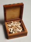 A SMALL BOX CONTAINING A QUANTITY OF FOSSILIZED SHARK TEETH.