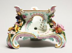 A 19TH CENTURY MEISSEN PORCELAIN STAND with painted decoration and encrusted with flowers. Cross