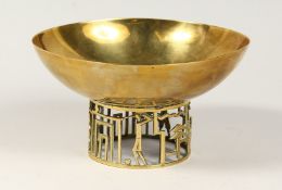 AN UNSUAL HAGLENAUR BRASS CIRCULAR BOWL, the pierced base modelled as golfing figures 7.5ins