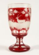 A GOOD BOHEMIAN RUBY GLASS GOBLET etched with deer in a landscape.