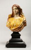 A 18TH CENTURY WOOD AND POLYCHROME DECORATED BUST OF A YOUNG LADY, on ebonised stepped base Bust