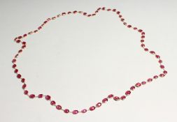 A GOOD 18CT GOLD RUBY SET CHAIN, set with four rubies